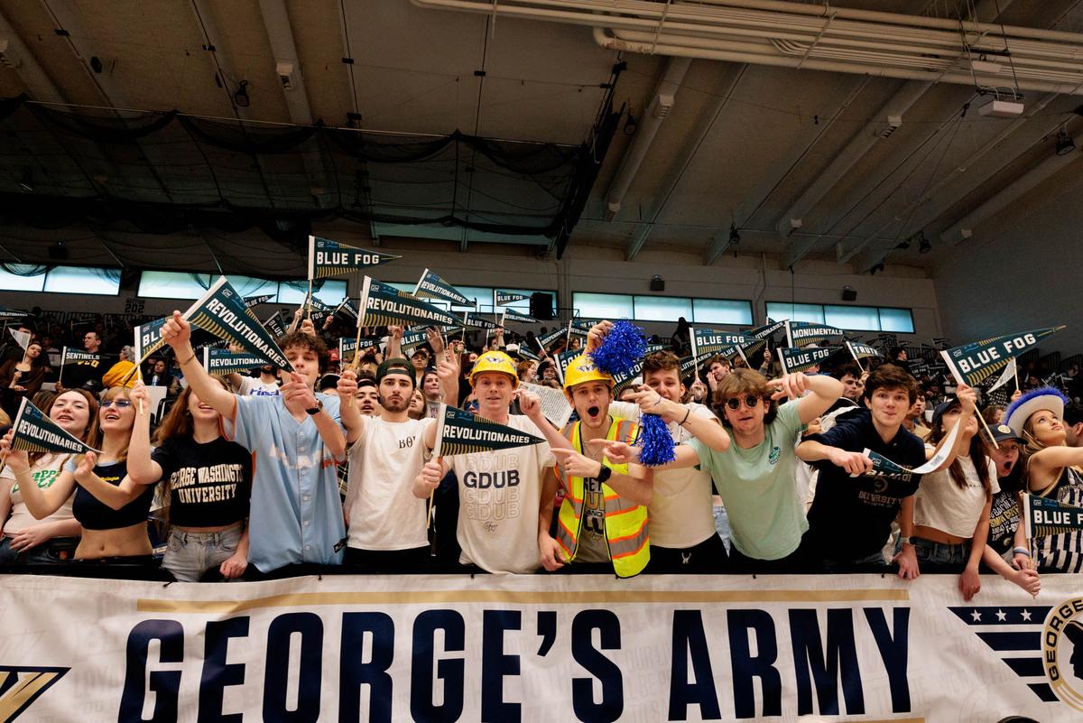 fans cheering above sign reading George's Army