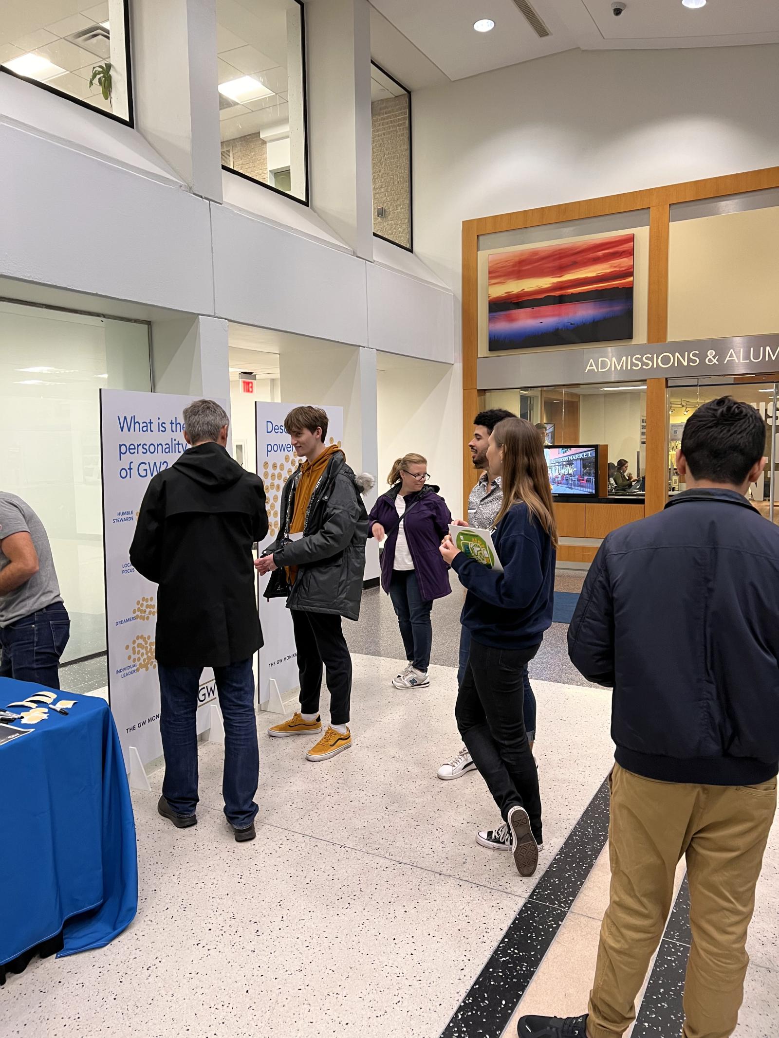 group of people standing around GW booth