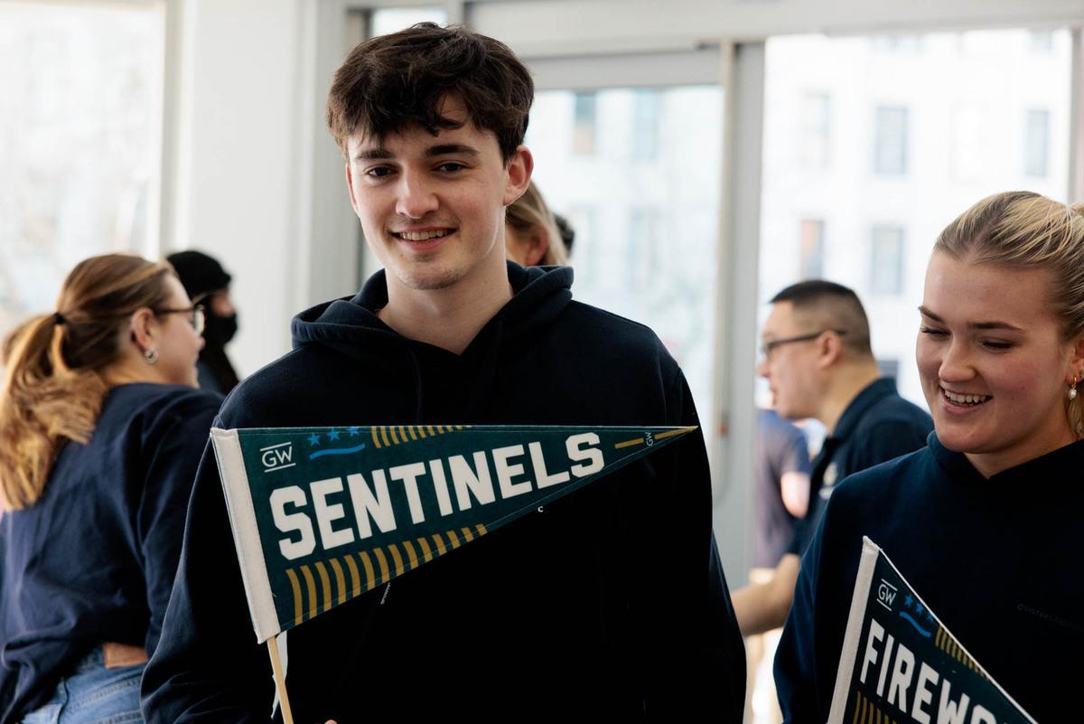 Fans holding pennants reading Sentinels and Fireworks